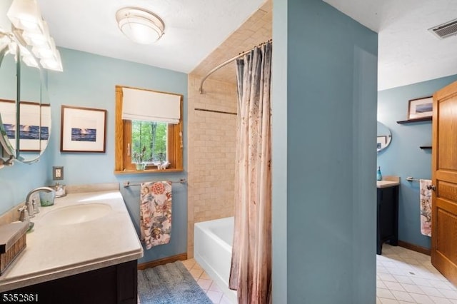 bathroom with tile patterned floors, vanity, and shower / bath combo with shower curtain