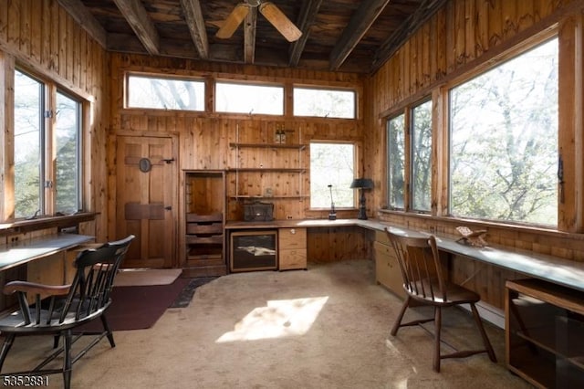 office area featuring wooden walls, ceiling fan, and a wealth of natural light