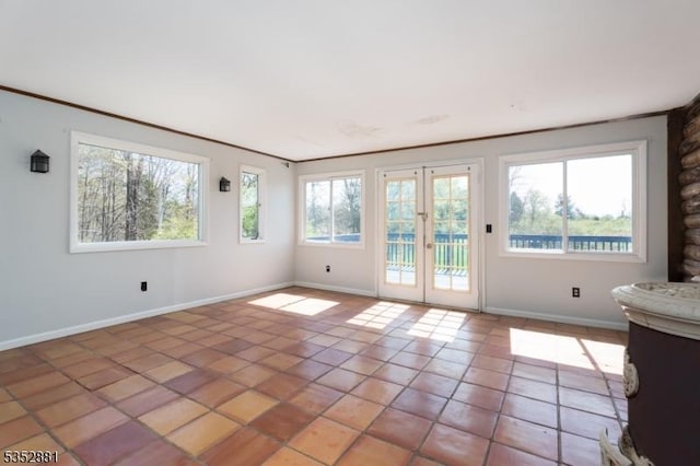 interior space with light tile patterned floors, baseboards, and french doors
