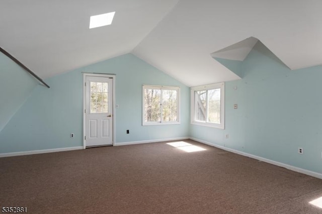 bonus room with a healthy amount of sunlight, carpet floors, baseboards, and vaulted ceiling