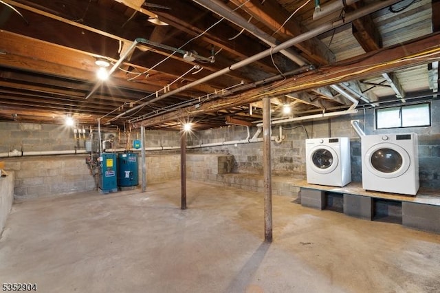 basement featuring water heater and washer and dryer