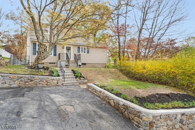 view of front of property featuring fence