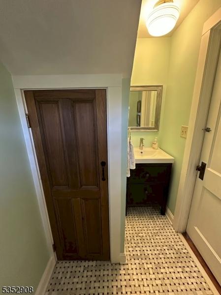 bathroom featuring tile patterned floors, vanity, and baseboards