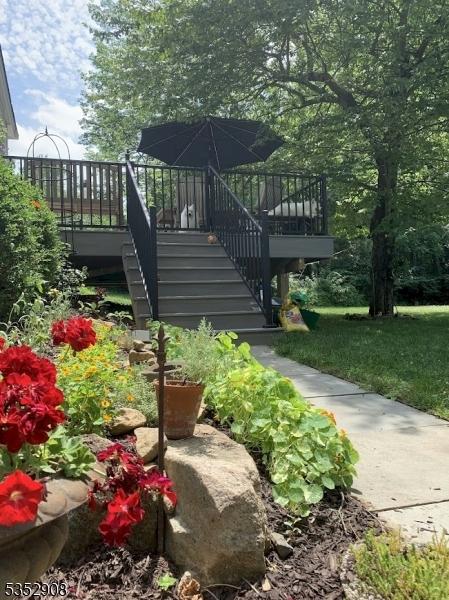 view of yard featuring a wooden deck and stairway