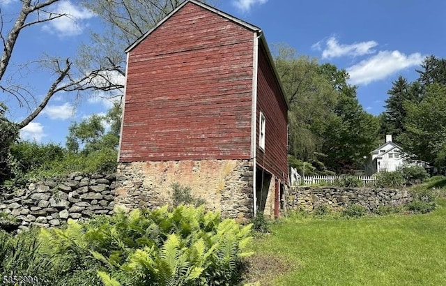 view of side of property with stone siding