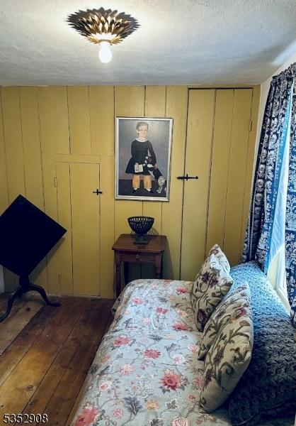 bedroom with hardwood / wood-style flooring and a textured ceiling