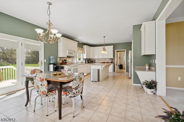 dining room featuring baseboards, an inviting chandelier, and light tile patterned floors