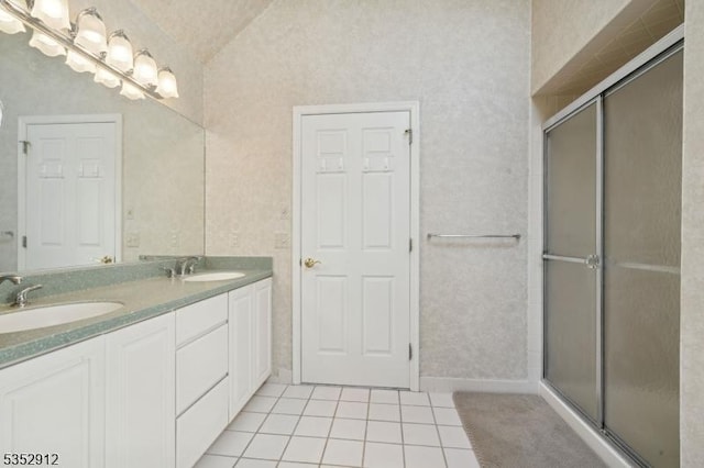 full bathroom featuring a shower stall, lofted ceiling, tile patterned floors, and a sink