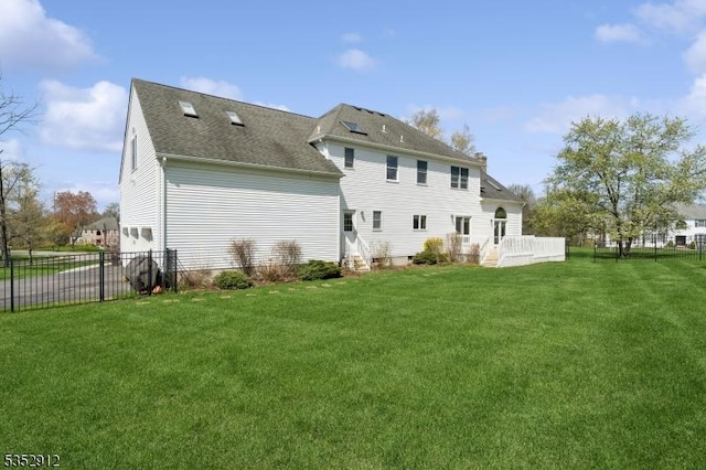 back of property with fence and a yard