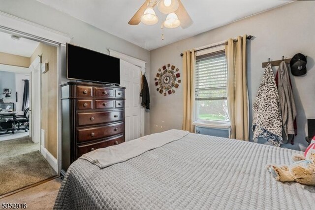 bedroom with ceiling fan and carpet floors
