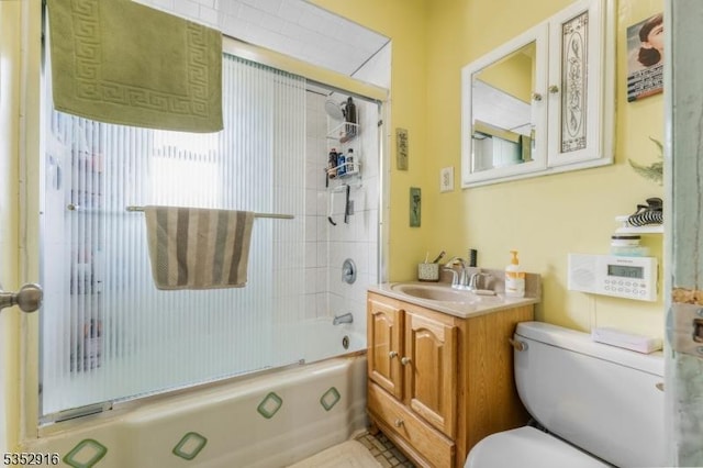 bathroom featuring toilet, shower / bath combination with glass door, and vanity