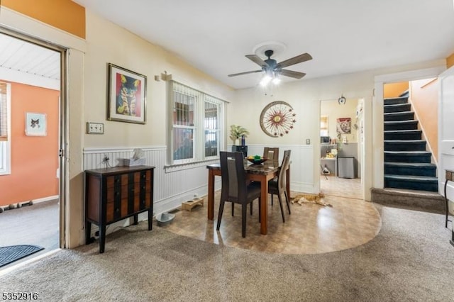 dining area featuring stairway, a ceiling fan, and carpet