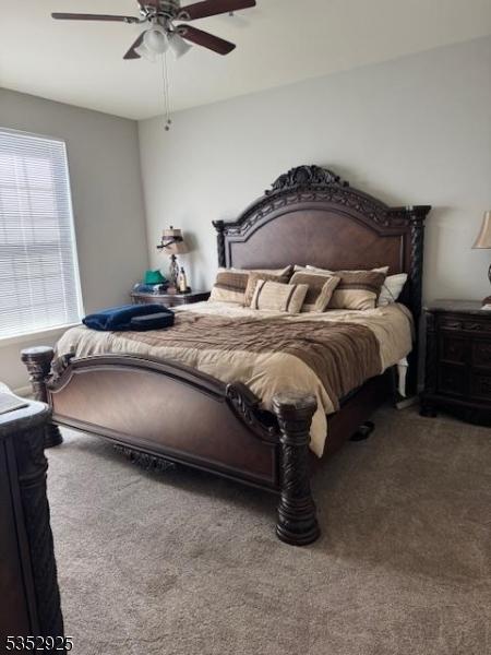 carpeted bedroom with a ceiling fan