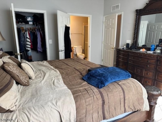 bedroom featuring visible vents, connected bathroom, a spacious closet, and a closet