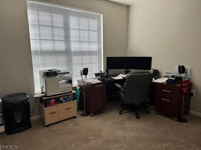 office with baseboards and light carpet