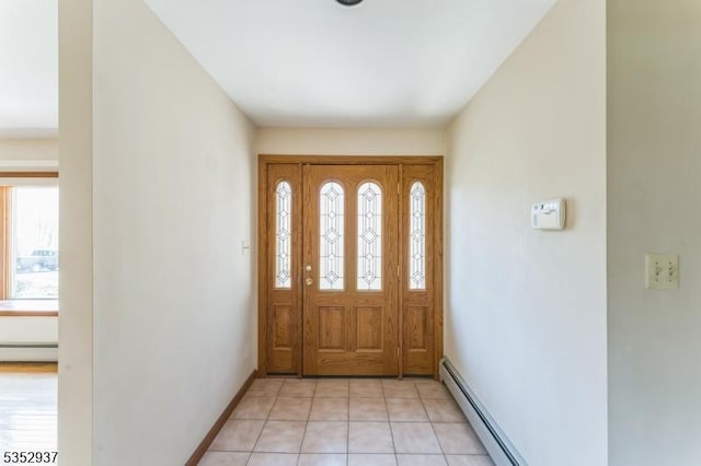 entrance foyer with baseboards, light tile patterned floors, and a baseboard radiator