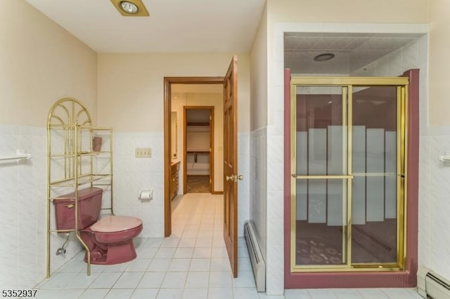 full bath featuring tile patterned flooring, a baseboard heating unit, and tile walls