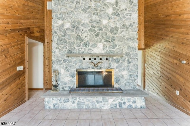 interior details with wood walls and a fireplace