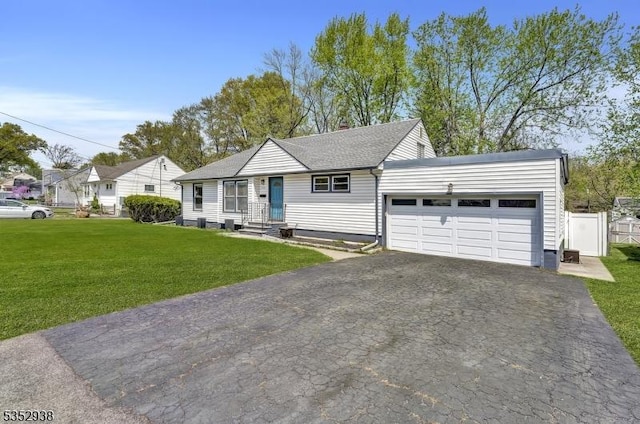 single story home with fence, aphalt driveway, a front yard, and a garage