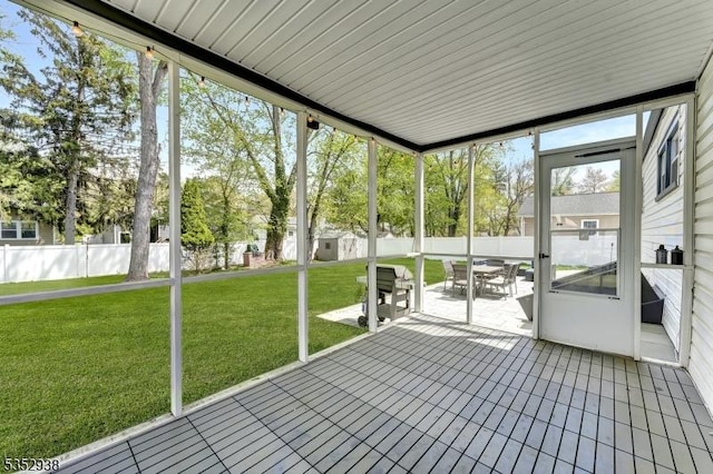 unfurnished sunroom with outdoor dining space