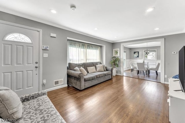 living area with a healthy amount of sunlight, recessed lighting, wood finished floors, and visible vents