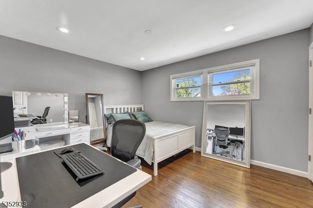 bedroom featuring baseboards, recessed lighting, and wood finished floors