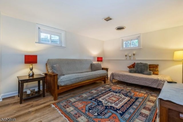 bedroom with visible vents and wood finished floors