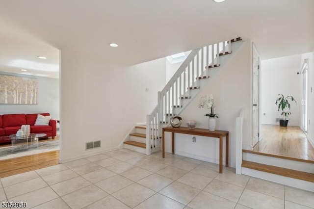 stairway with tile patterned floors, visible vents, recessed lighting, and baseboards