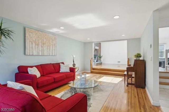 living area with wood finished floors, recessed lighting, and baseboards