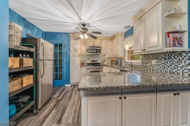 4 Broad View Pl, Raritan Twp, NJ 08822 - kitchen featuring appliances with stainless steel finishes, open shelves, wood finished floors, dark stone countertops, and decorative backsplash
