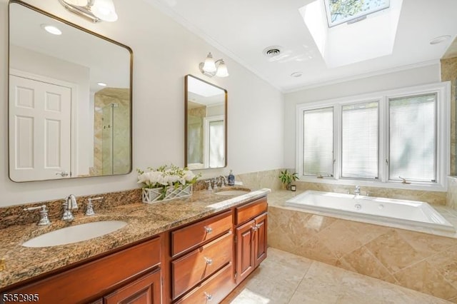full bath with visible vents, a sink, and a wealth of natural light