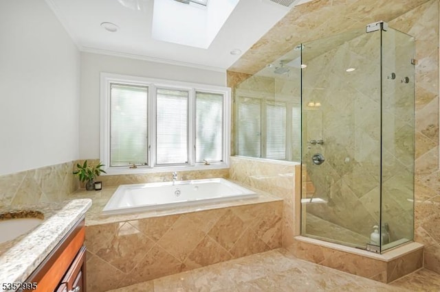 bathroom featuring a garden tub, ornamental molding, vanity, a shower stall, and a skylight