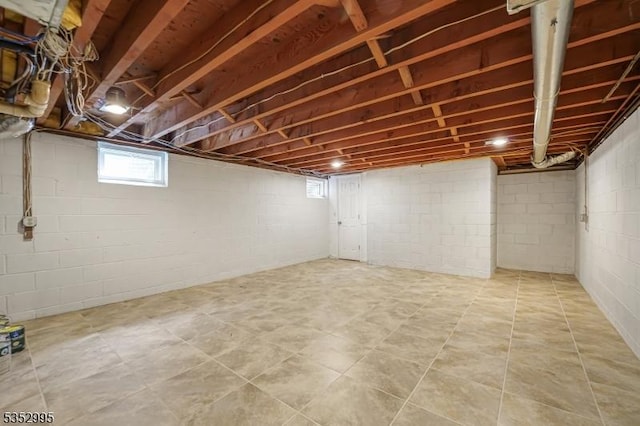 below grade area featuring tile patterned floors and a wealth of natural light