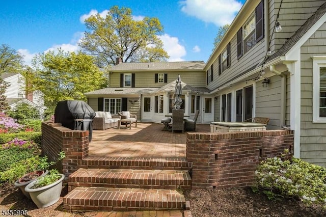 back of house featuring a patio, outdoor lounge area, and a chimney