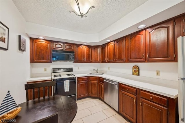 kitchen featuring black microwave, stainless steel dishwasher, range with gas stovetop, a sink, and a textured ceiling
