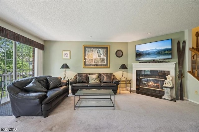 carpeted living room with a textured ceiling and a fireplace with flush hearth