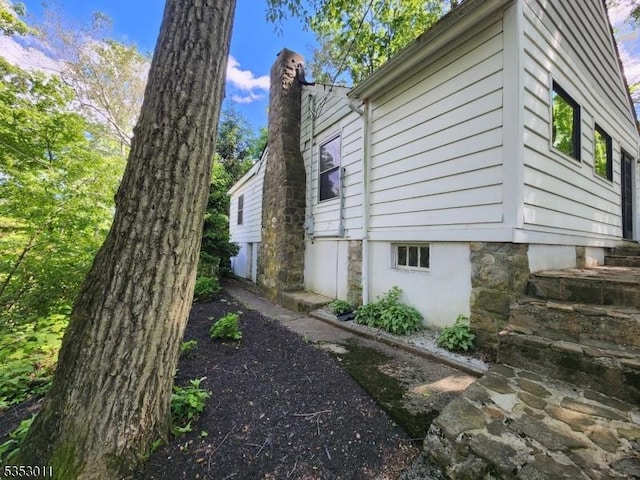 7 Raccoon Island Rd, Jefferson Twp, NJ 07849 - view of home's exterior with a chimney