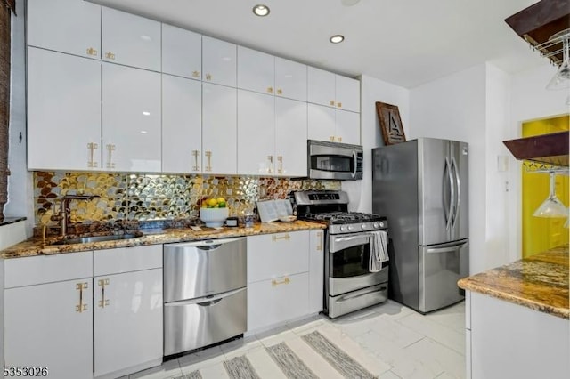 kitchen with recessed lighting, decorative backsplash, stainless steel appliances, white cabinetry, and stone countertops