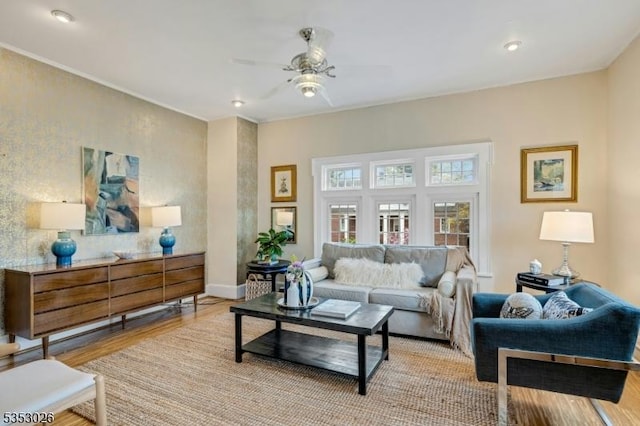 living room featuring baseboards, recessed lighting, ceiling fan, and light wood-style flooring