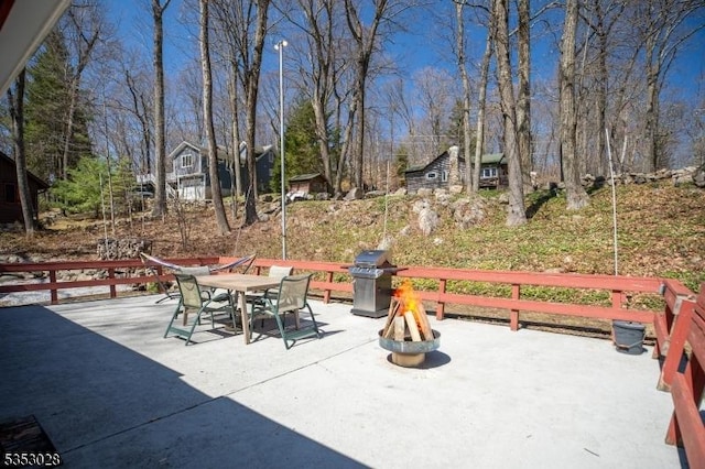 view of patio / terrace with outdoor dining space, a grill, and an outdoor fire pit