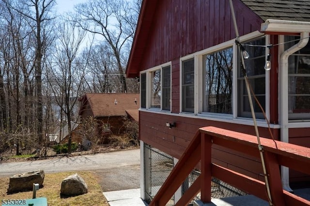 view of side of property with a shingled roof