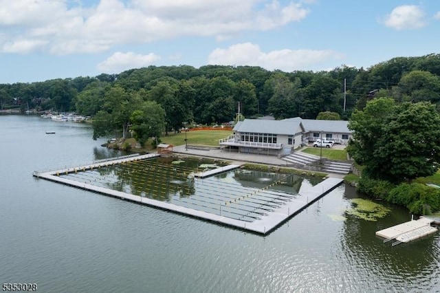 exterior space with a wooded view and a water view