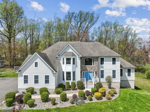 190 Main St, Union Twp, NJ 08827 - back of house featuring a shingled roof, a yard, and stone siding