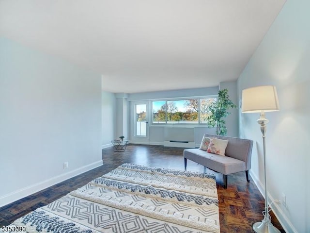 sitting room featuring baseboard heating and baseboards