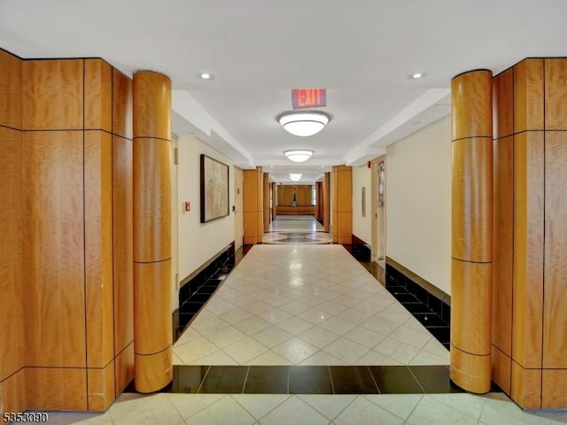 hallway with recessed lighting, tile patterned flooring, and baseboards