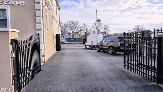 view of road featuring driveway, a gated entry, and a gate