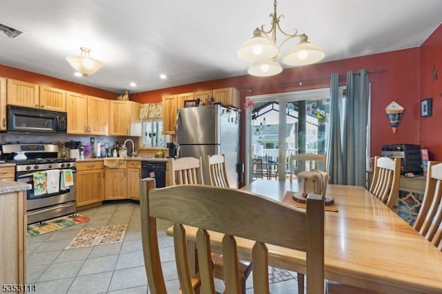 kitchen with an inviting chandelier, light tile patterned floors, light countertops, black appliances, and visible vents