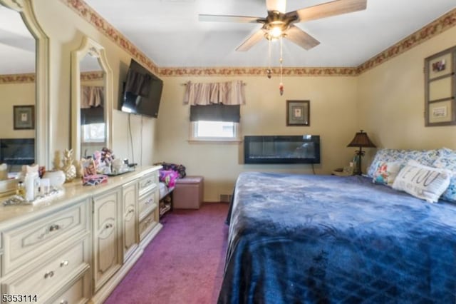 bedroom featuring ceiling fan and dark colored carpet
