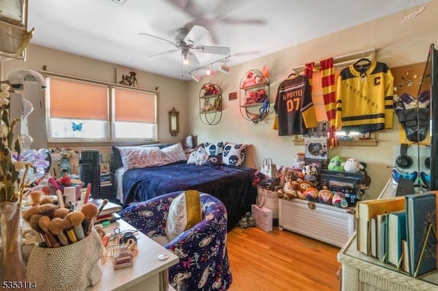 bedroom with wood finished floors and a ceiling fan