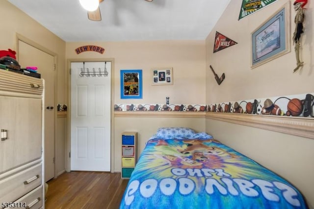 bedroom featuring a ceiling fan and wood finished floors